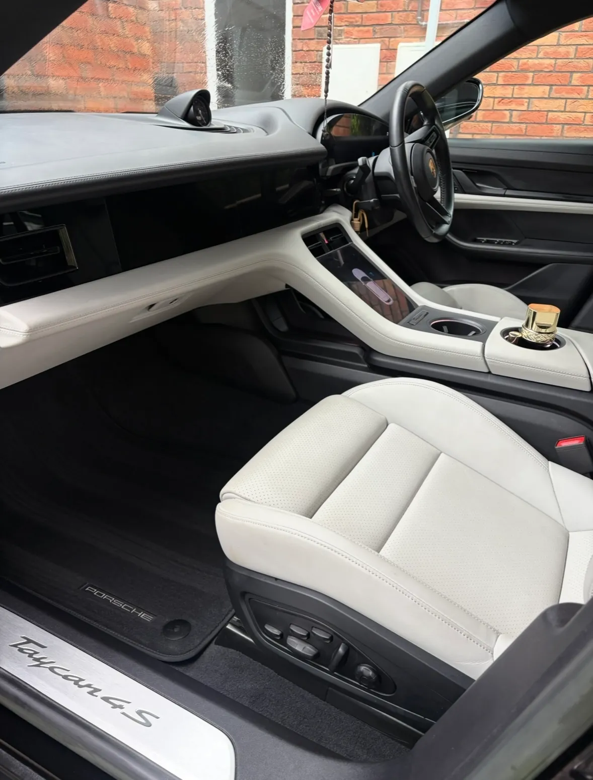White leather passenger seat and console in a Porsche Taycan